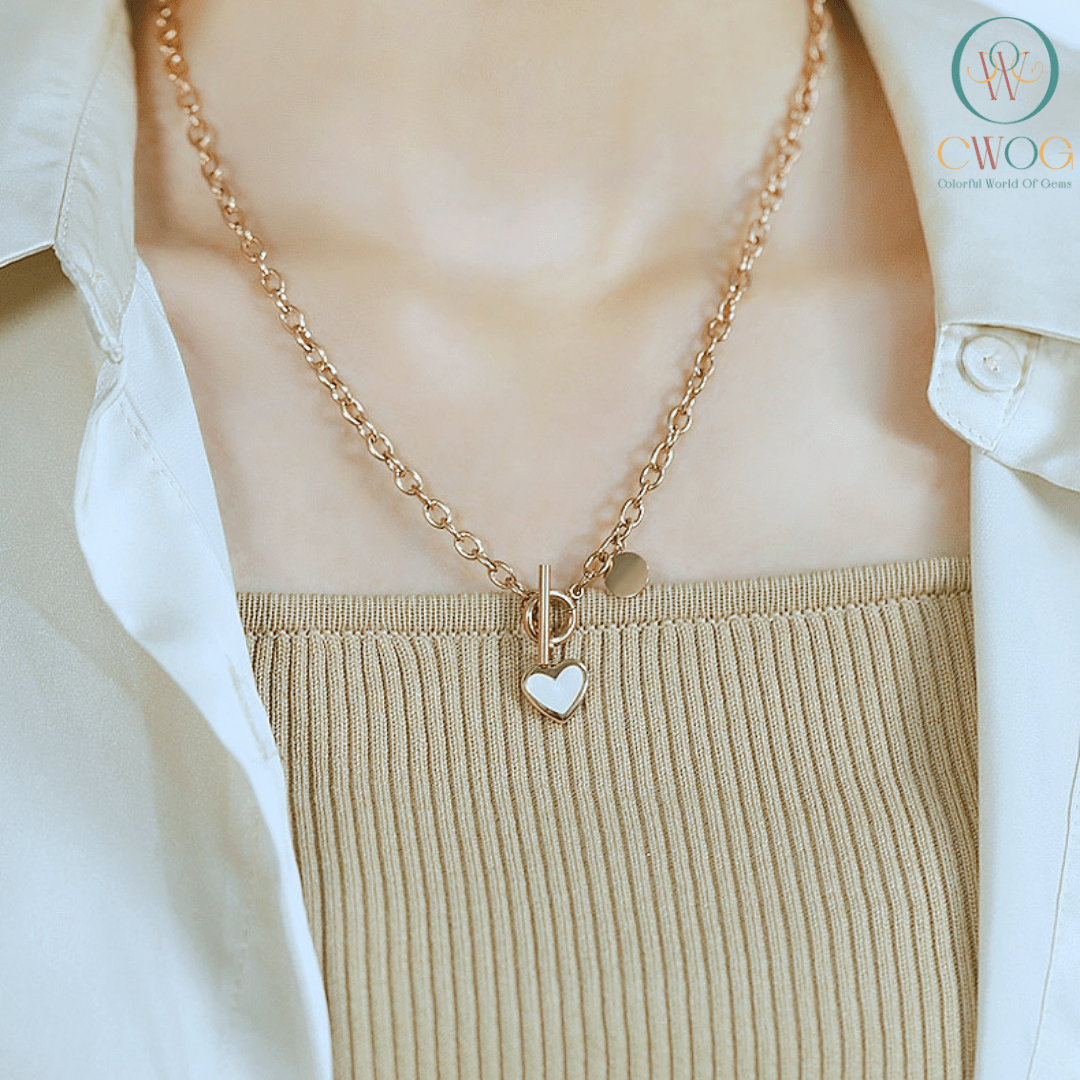 a girl wear a heart charm necklace and looking beautiful.